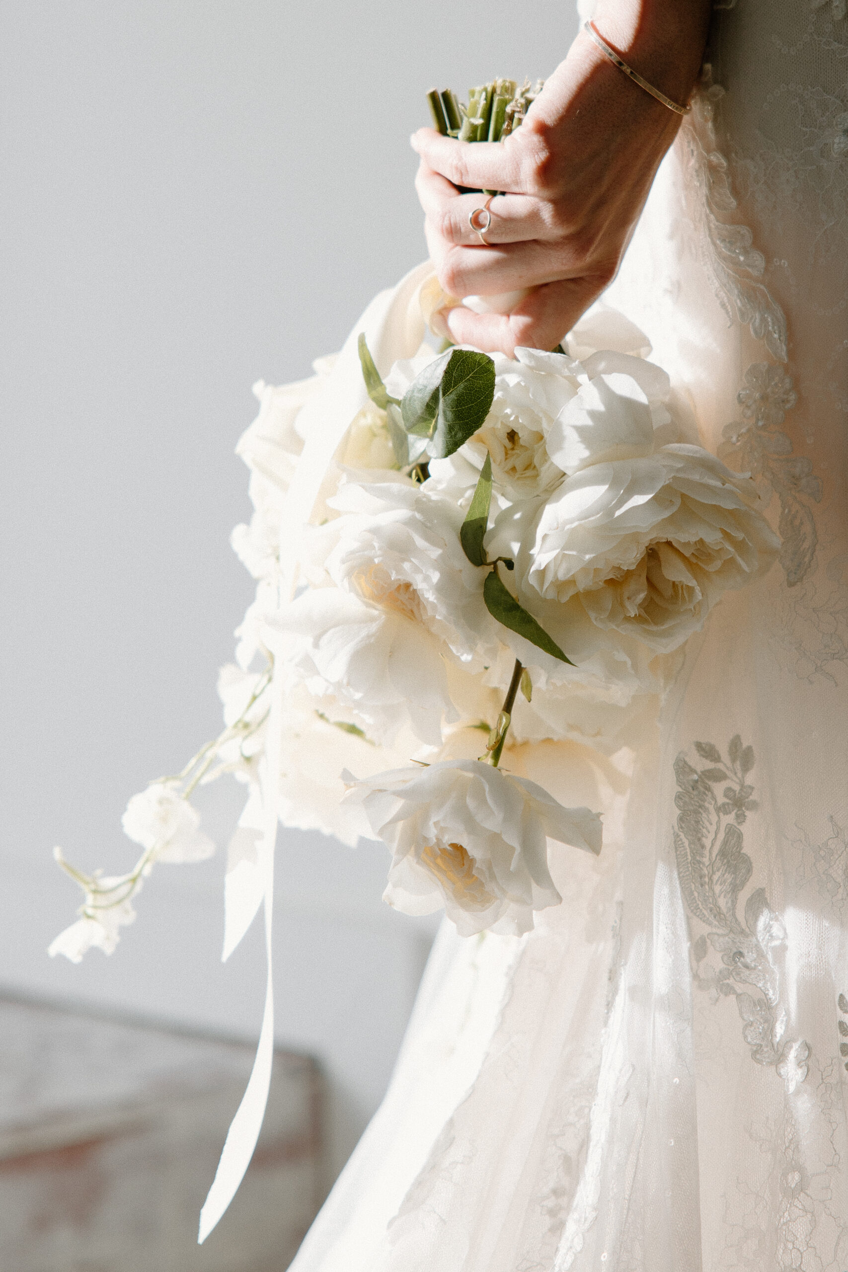 Bride holding her wedding bouquet in white and luxury florals